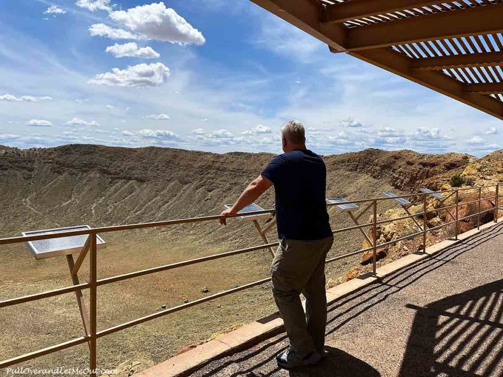 a man looking at the Meteor Crater in Arizona