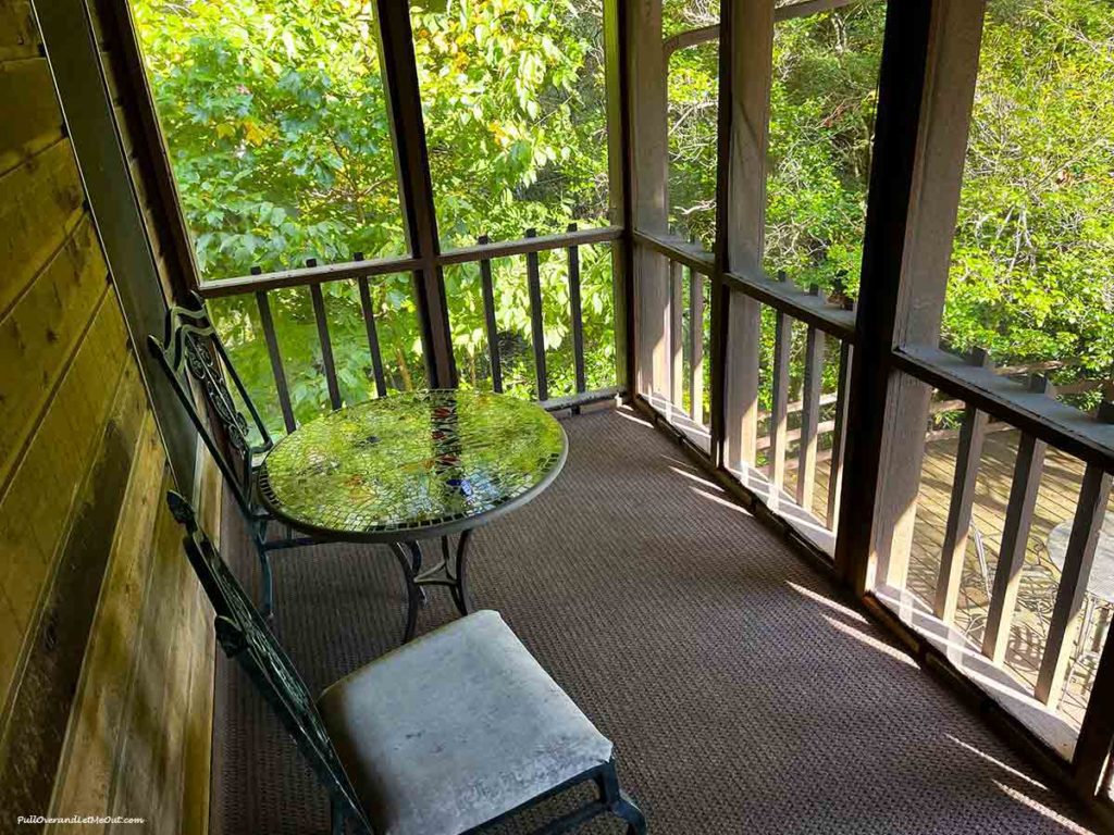 a screened porch in the woods