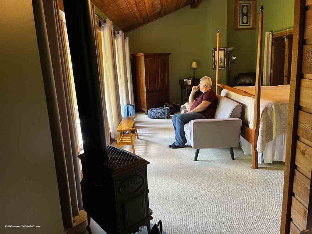 a man sitting on a sofa in a bedroom