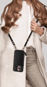 a woman carrying a cross body phone case/wallet