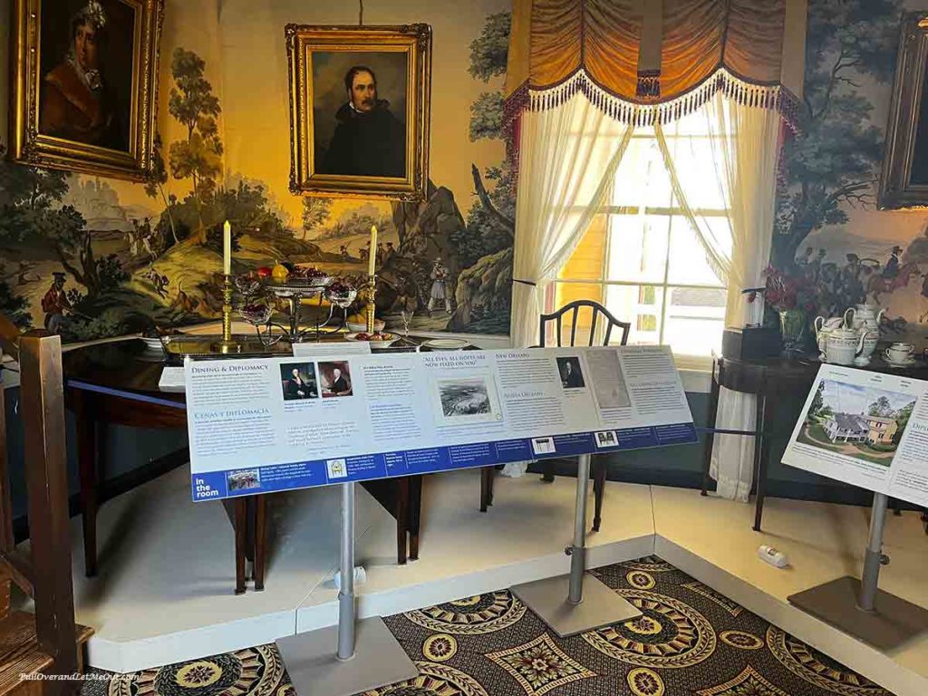 a dining table with a portrait above it