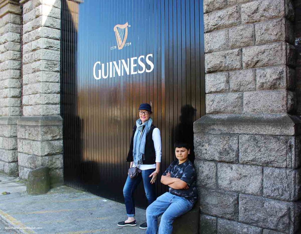 a woman and a boy outside at the Guinness gate in Dublin