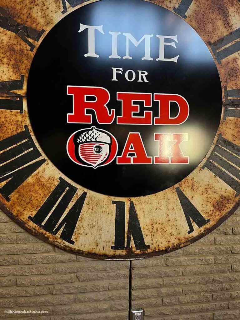 a sign that is a clock that says Red Oak Time