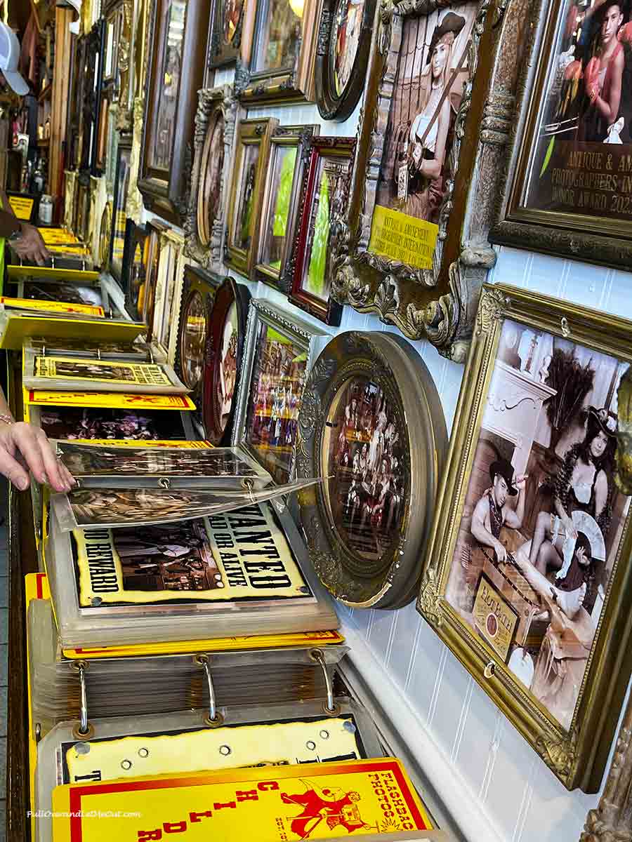 someone looking at books of photographs taken in old-fashioned clothing
