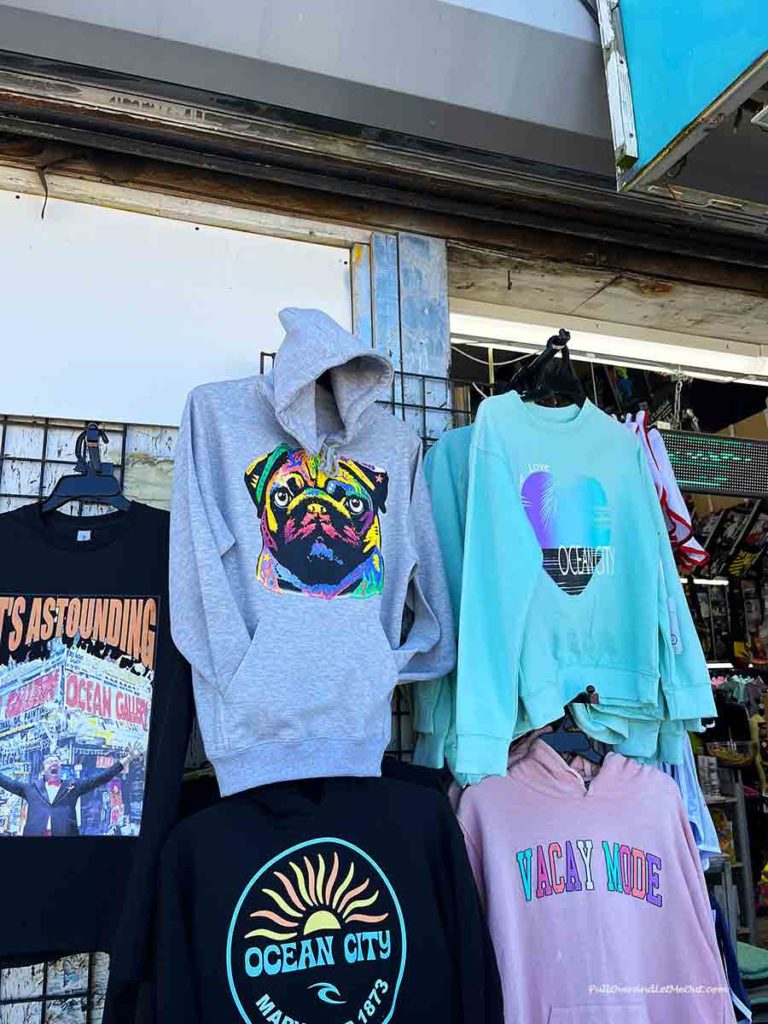 a display of t-shirts and hoodies with pictures on them.