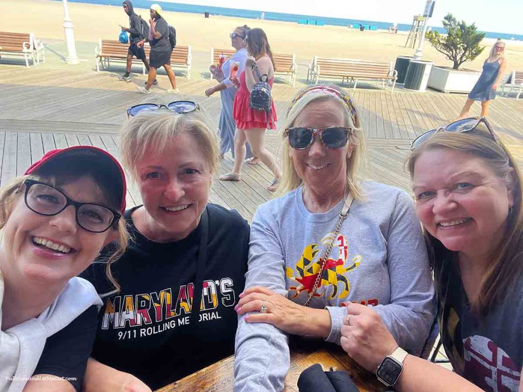 four women taking a selfie at the beach