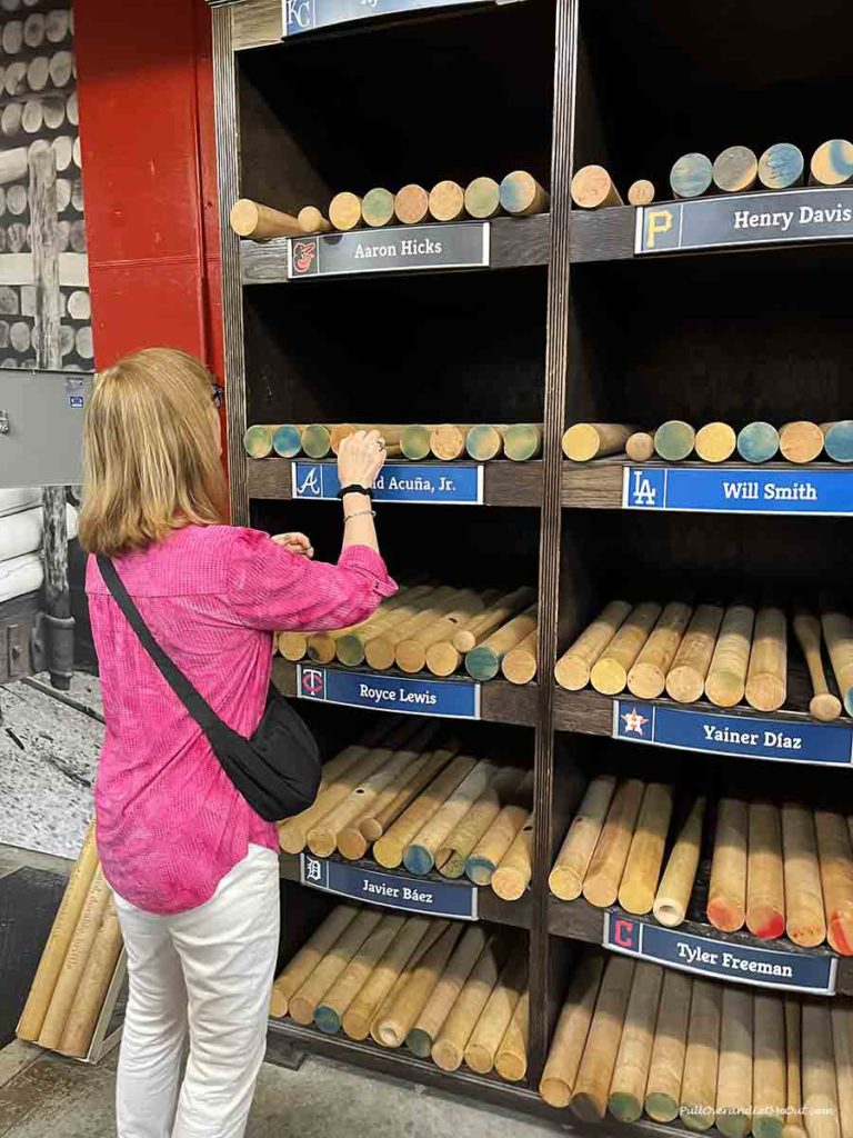 a woman looking at wooden billets