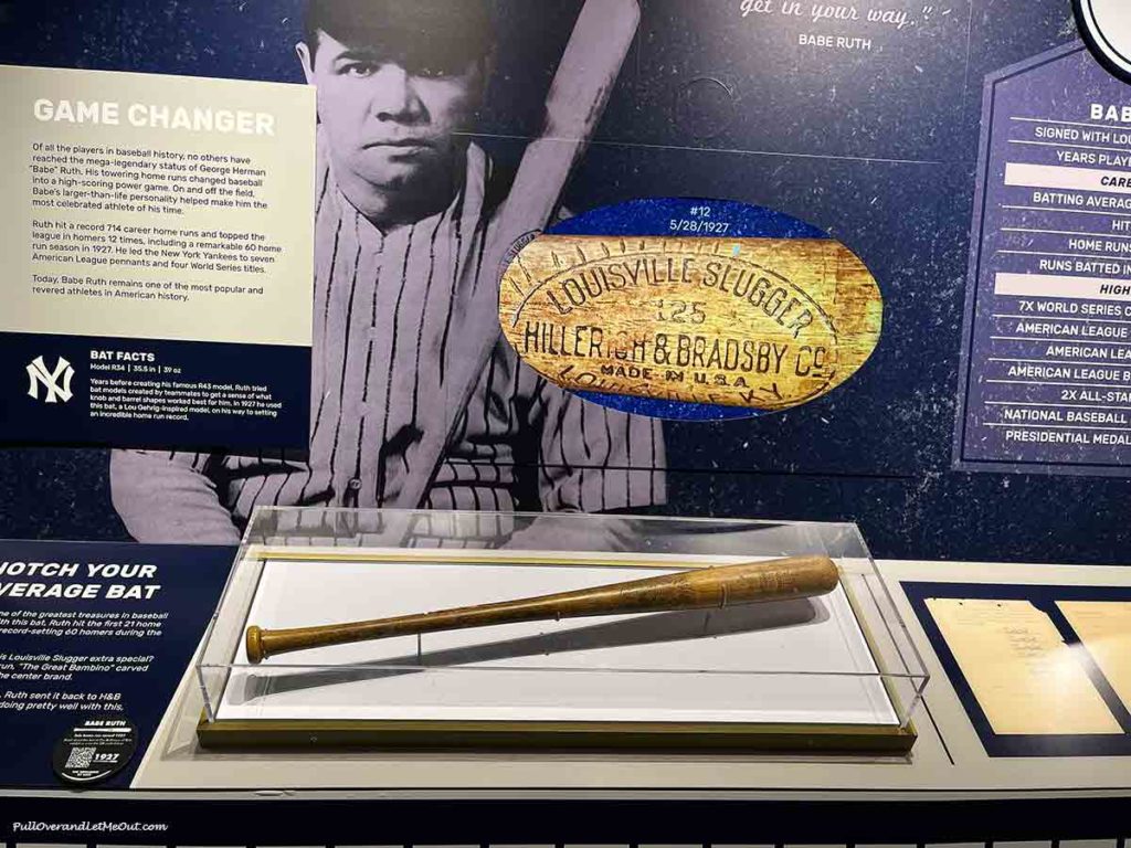 a Louisville Slugger baseball bat in a display case