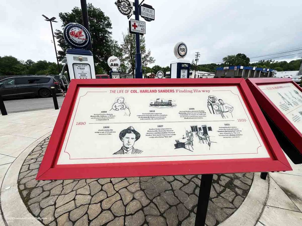 An informational plaque in front of an old-style gas pump