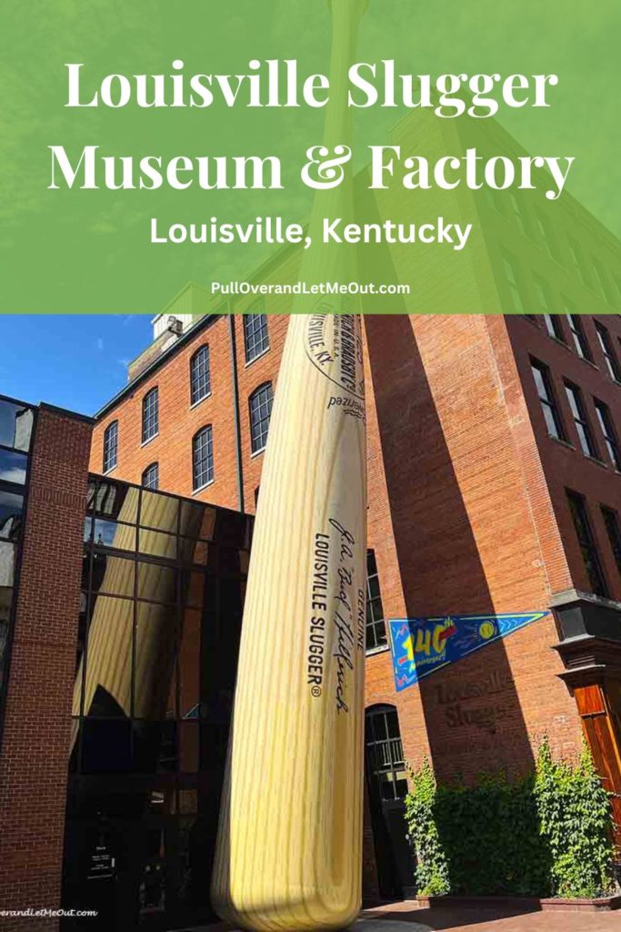 a giant baseball bat in front of a brick building