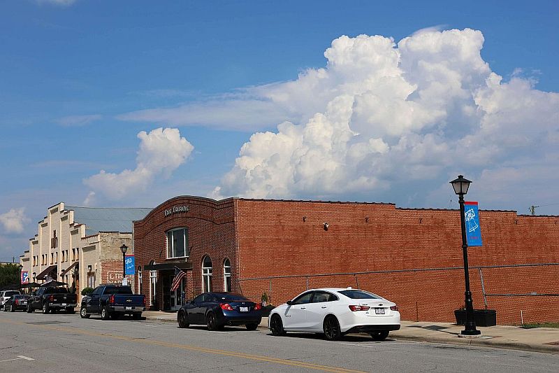 a brick building on a main street in a small town