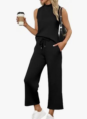 a woman wearing a two piece travel set and holding a coffee