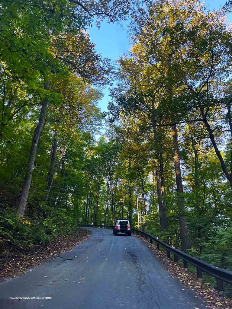 a mountain road with a jeep on it