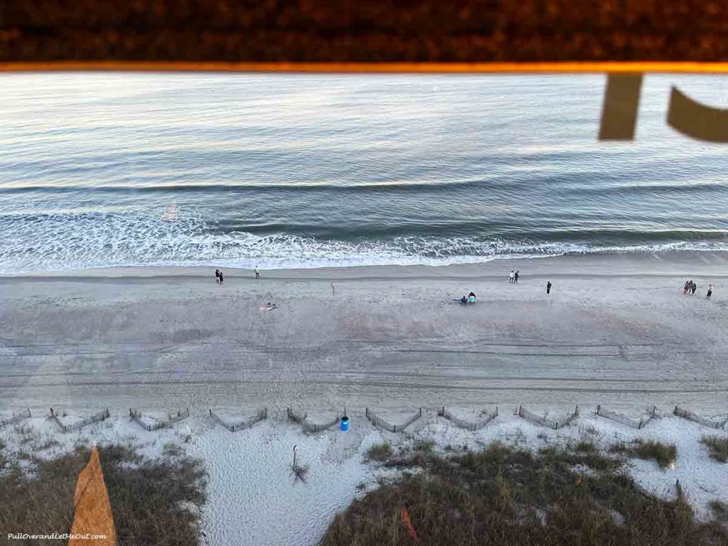 a view of the beach from inside a glass gondola