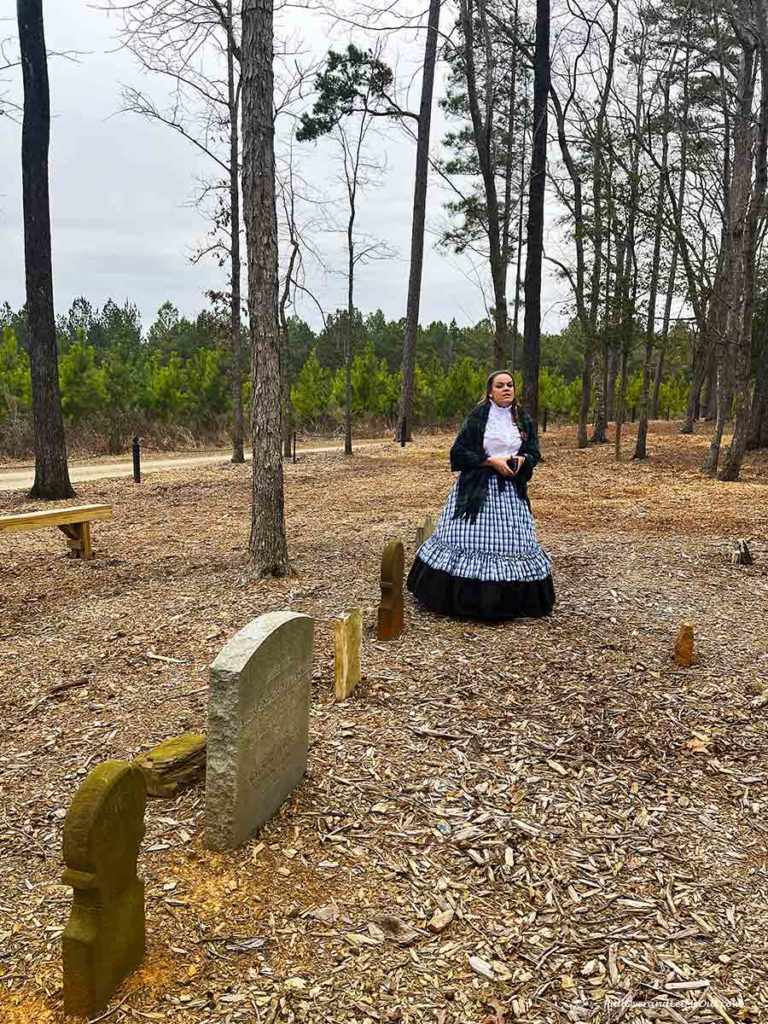 a costumed tour guide in a graveyard