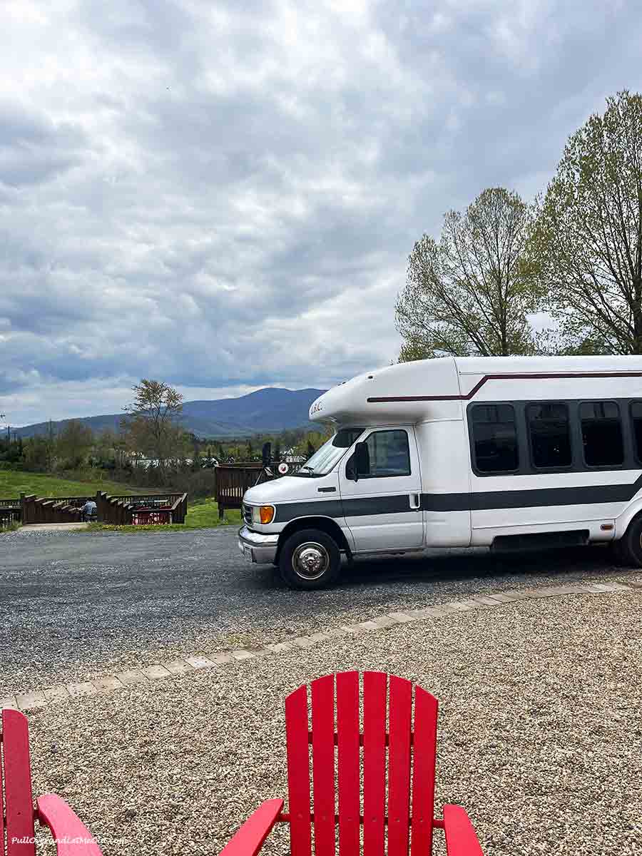 a coach bus parked in front of a mountain view
