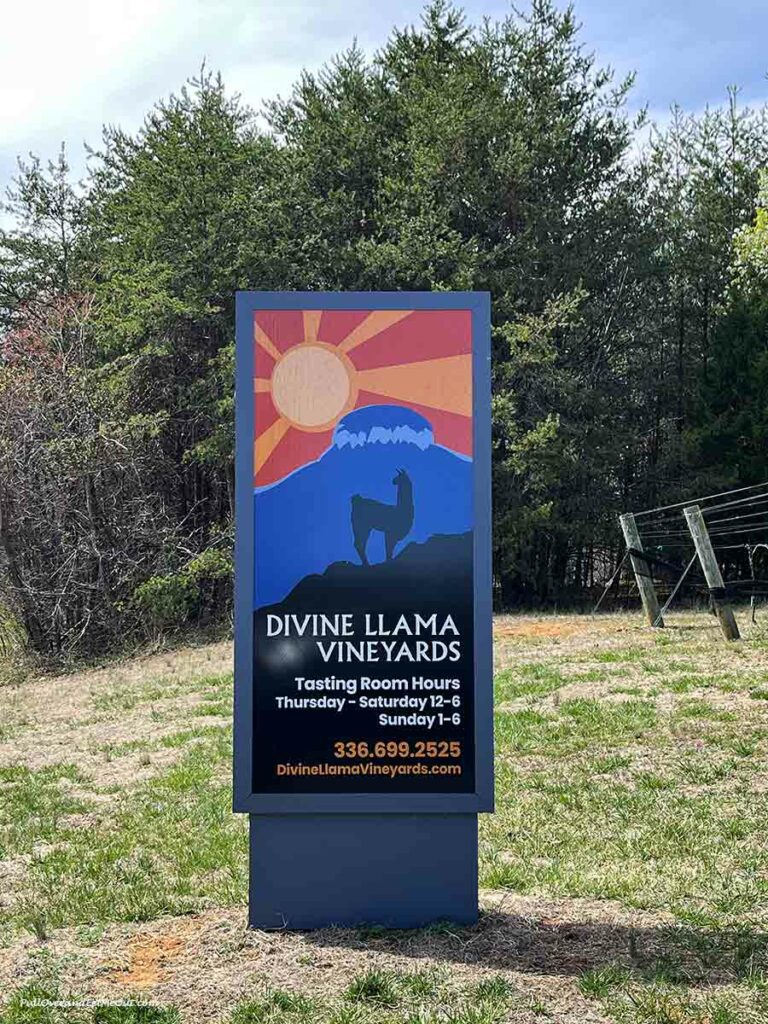 a sign at the entrance to Divine Llama Vineyards