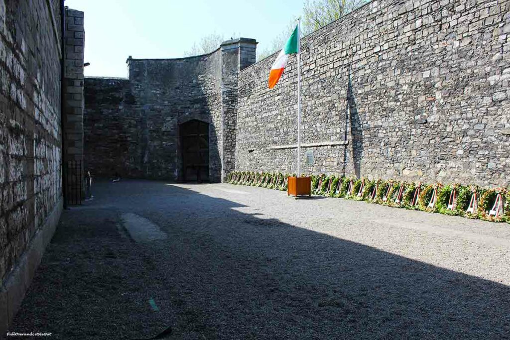 a stone wall surrounding a courtyard in a prison