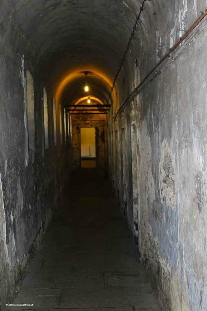 a dark corridor in an old prison