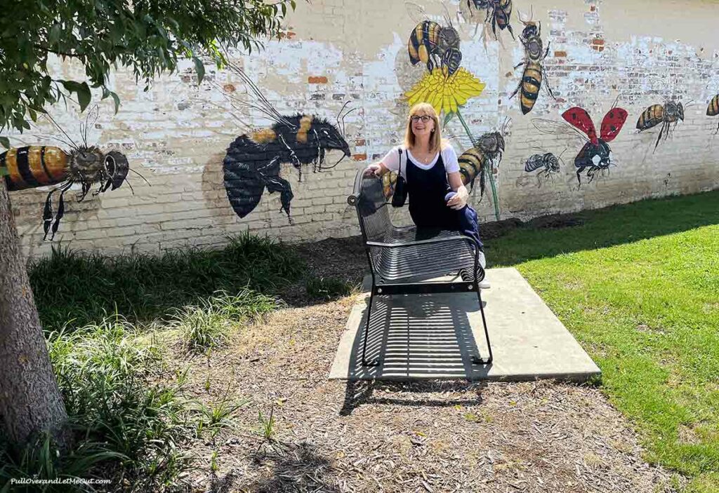 a woman sitting on a park bench