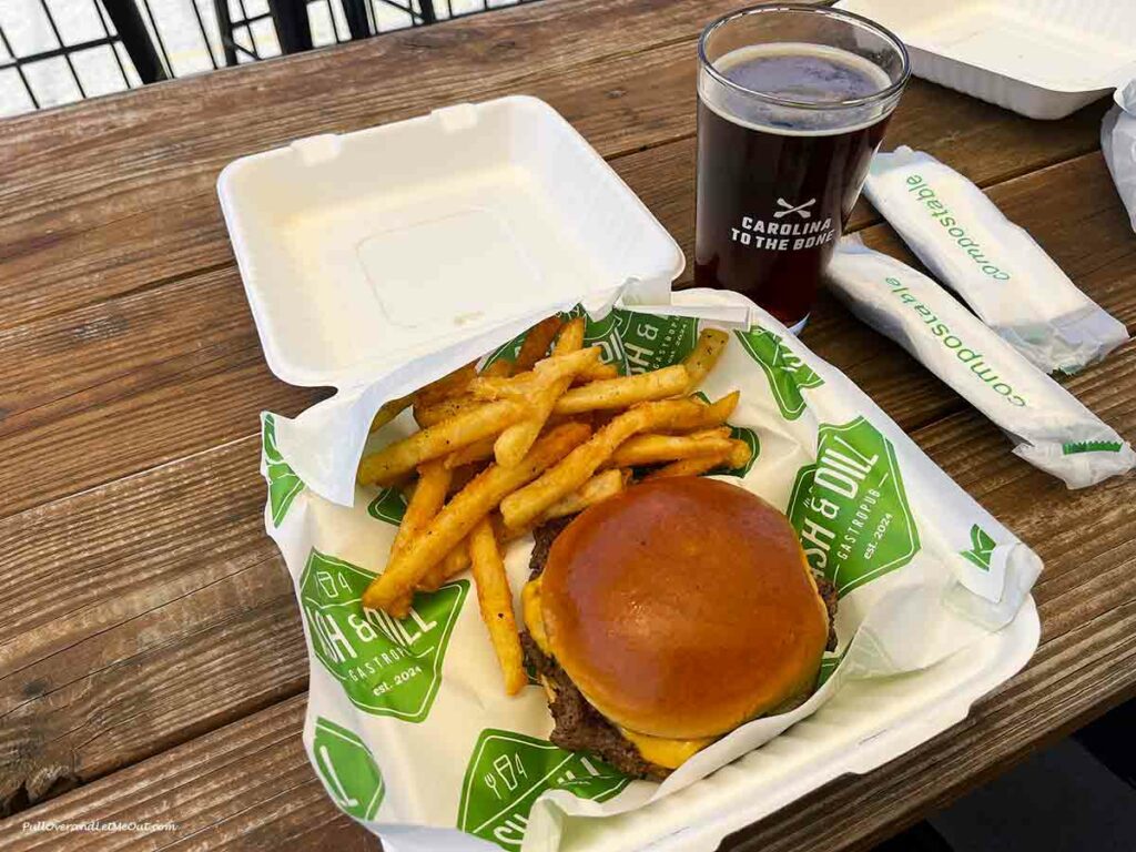 A picture of a burger & fries in a to-go box