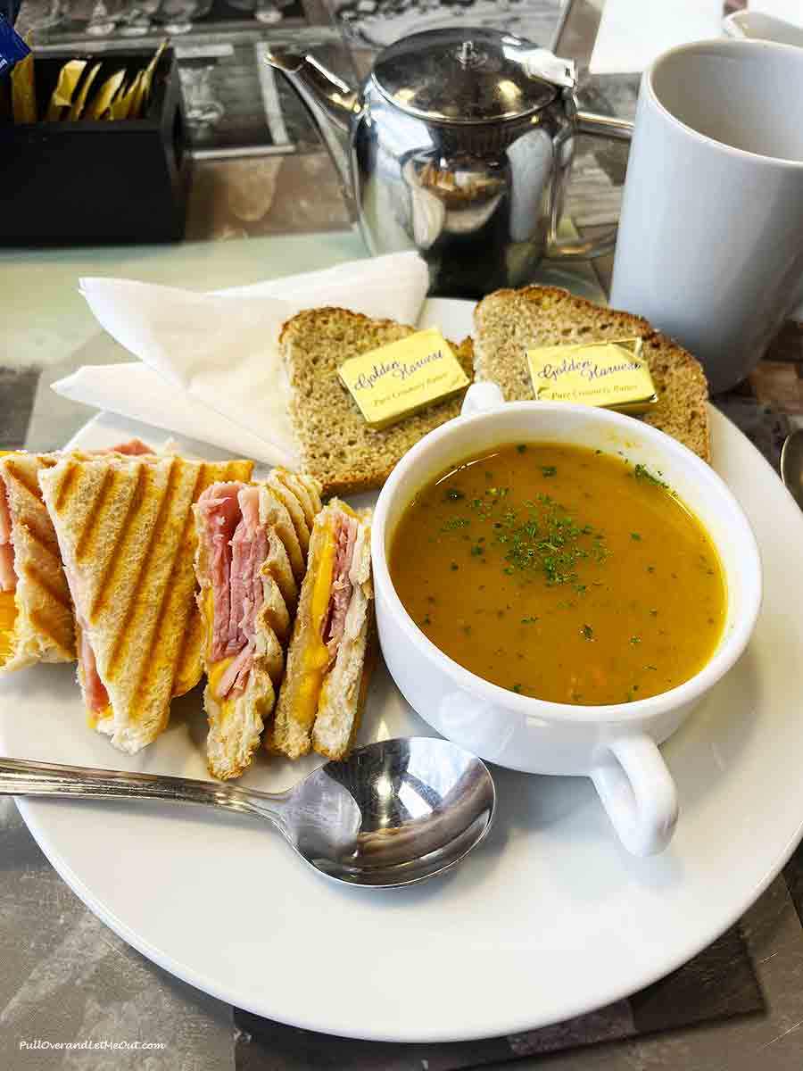 a toastie sandwich with a cup of soup