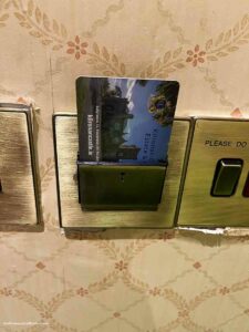 a room key card in a slot that turns the electricity on in a room