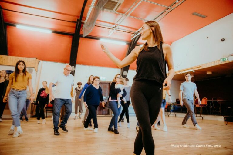 a woman teaching a class of dancers