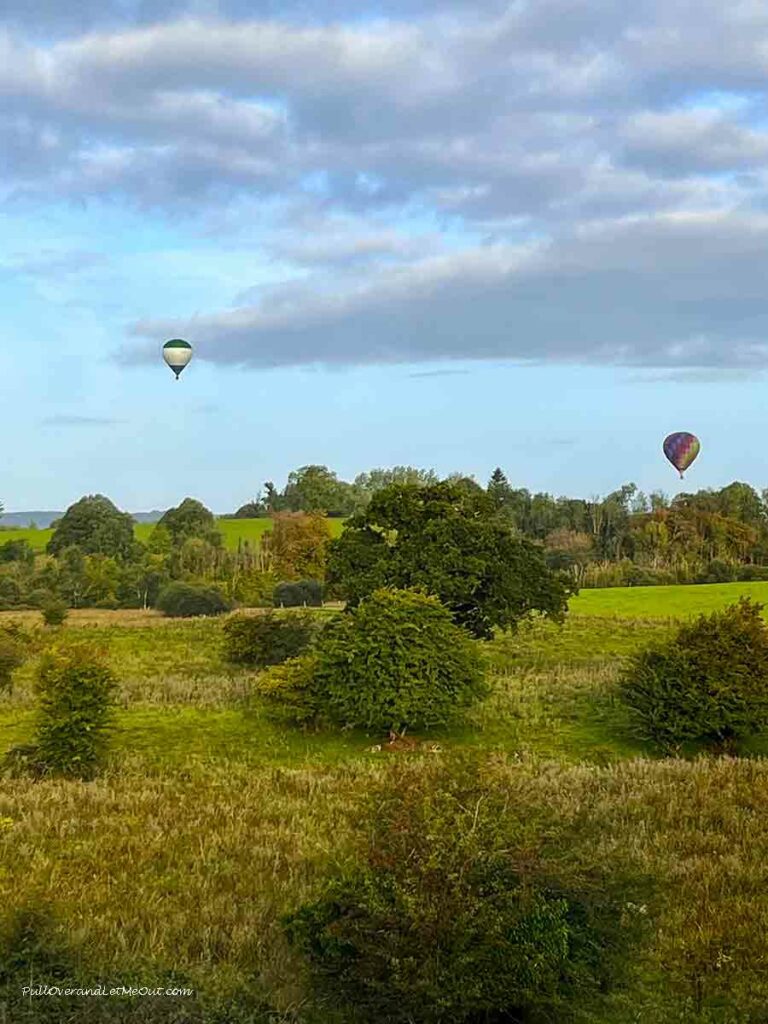 two hot air balloons over the country side