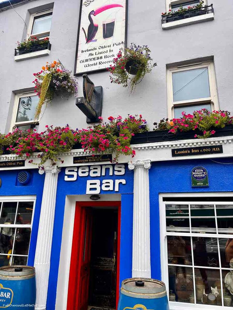 An Irish pub with the name of the bar over the door that says Seans Bar
